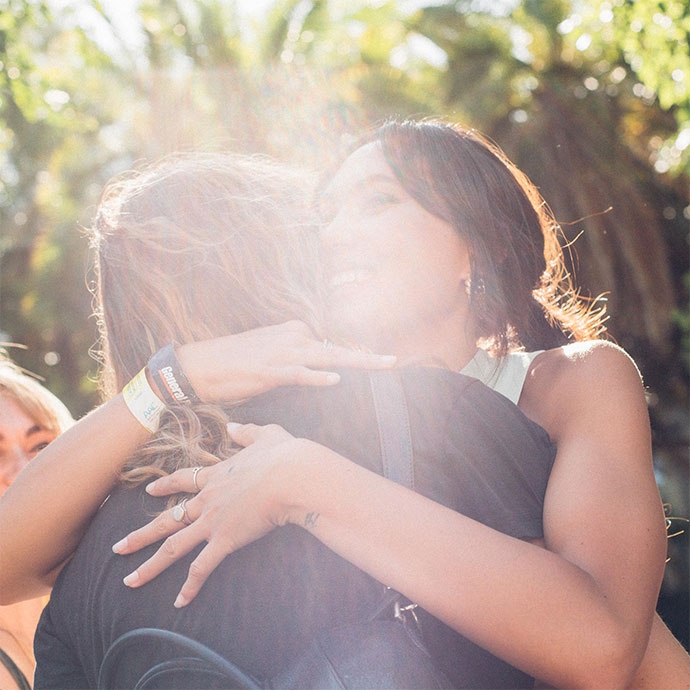 Two young friends hugging in Auckland