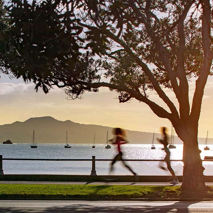 People running along the esplanade at Auckland's Mission Bay