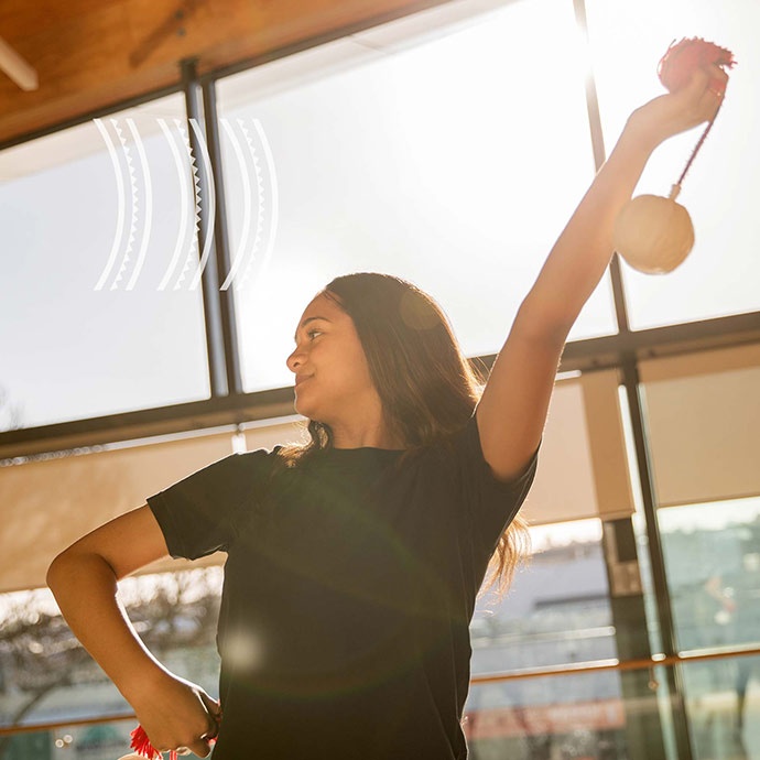 A young woman practices poi